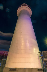 Low angle view of illuminated building against sky at night