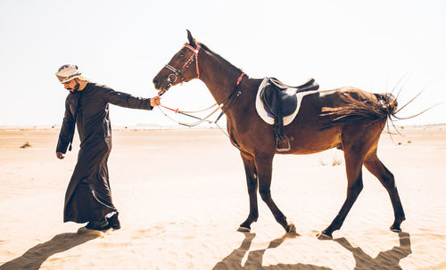 Full length of man on desert against sky