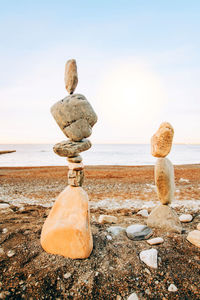 Rocks on beach against sky