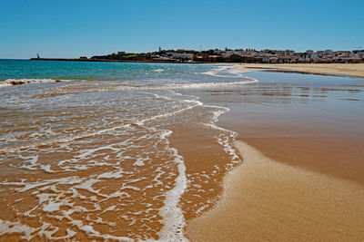 Scenic view of beach against clear sky