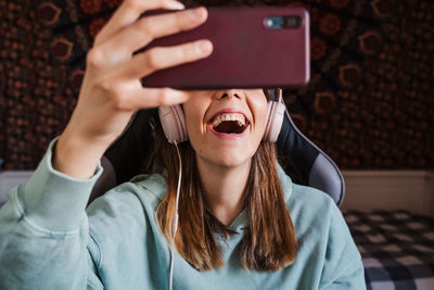 Cheerful woman talking on video call at home