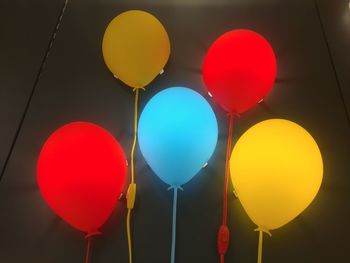 Low angle view of balloons against sky