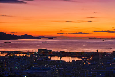 High angle view of townscape by sea against romantic sky in the morning