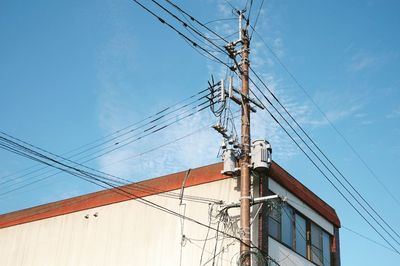 Low angle view of electricity pylon against sky