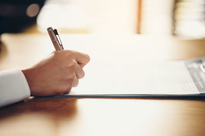 Close-up of hand holding book