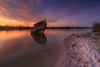 Scenic view of beach against sky during sunset