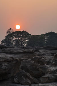 Scenic view of rock formation against sky during sunset