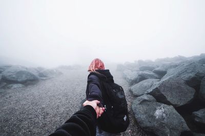 Woman standing on mountain road during winter