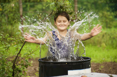 Rear view of a young girl splashing water