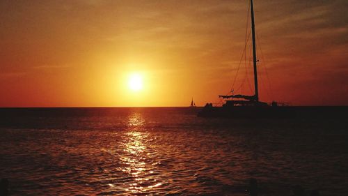 Silhouette of sailboat sailing on sea