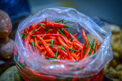Close-up of red chili peppers in container