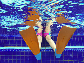 Low angle view of person wearing diving flipper in swimming pool