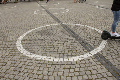 Low section of man standing on footpath