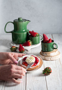 Fruit still life with strawberries and green tea set, strawberry cake with cream