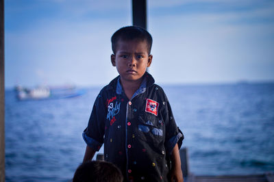 Side view of man standing against sea