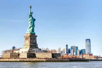 Statue of liberty with city in background