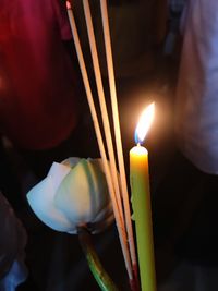 Close-up of lit candles in temple