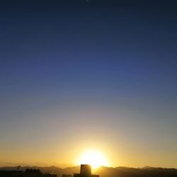 Silhouette landscape against clear sky during sunset