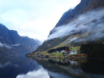 Scenic view of lake and mountains against sky