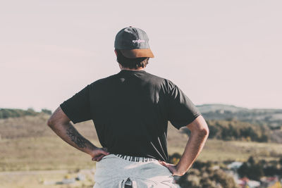 Rear view of man standing against sky