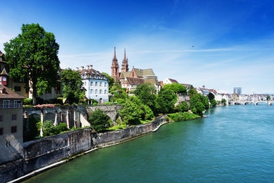 View of river in city against blue sky