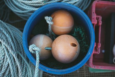 High angle view of buoys in bucket