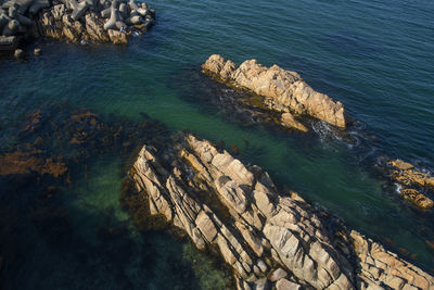 High angle view of rocks on sea