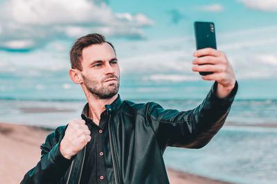 Portrait of young man photographing