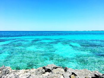 Scenic view of sea against clear blue sky