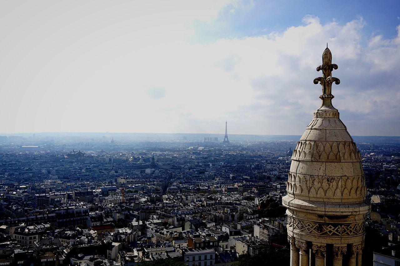 architecture, religion, sky, city, building exterior, travel destinations, cityscape, outdoors, statue, urban skyline, no people, built structure, cloud - sky, day, place of worship, water