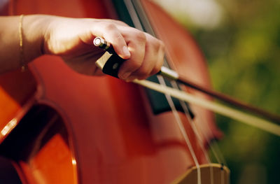 Cropped hand of man playing car