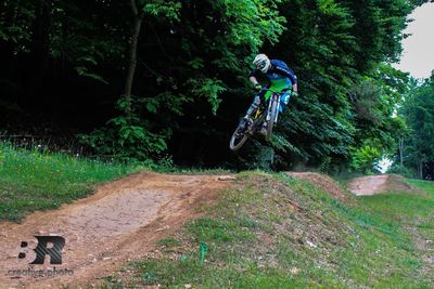 Man riding bicycle in forest