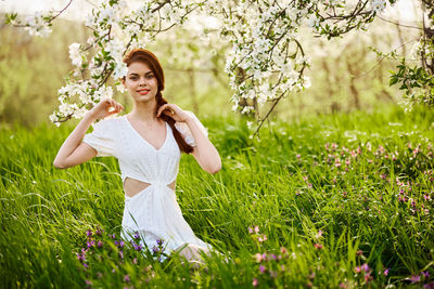 Side view of young woman standing on field