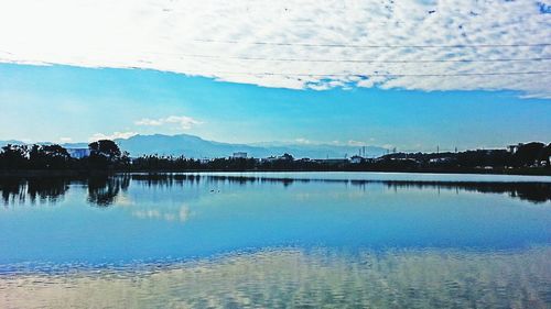 Scenic view of calm lake against sky