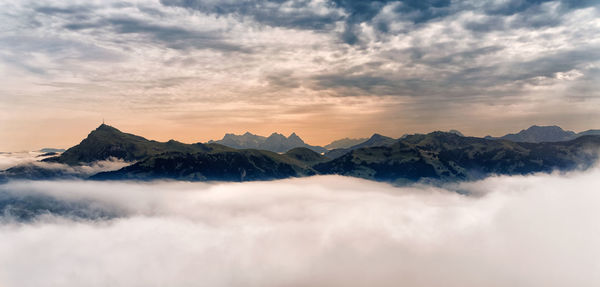 Scenic view of snowcapped mountains against sky during sunset