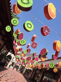 Low angle view of multi colored balloons against sky