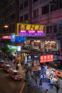 High angle view of people on city street at night