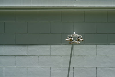 Electric lamp on tiled floor against wall at home