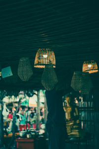 People in illuminated market at night