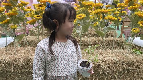 Rear view of woman with arms raised
