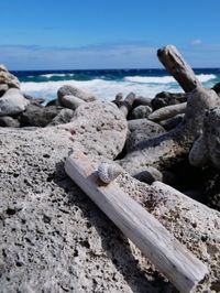 Close-up of rocks on beach against sky