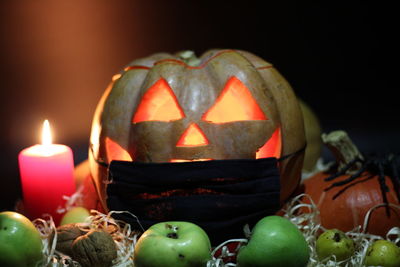 Close-up of illuminated pumpkin against black background