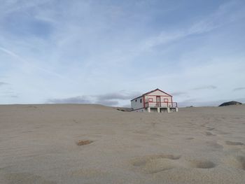 House on beach against sky