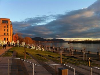 Stairway by river against sky during sunset