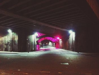 Empty illuminated street lights at night