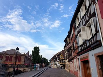 Street amidst buildings in city against sky