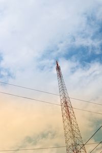 Low angle view of communications tower against sky