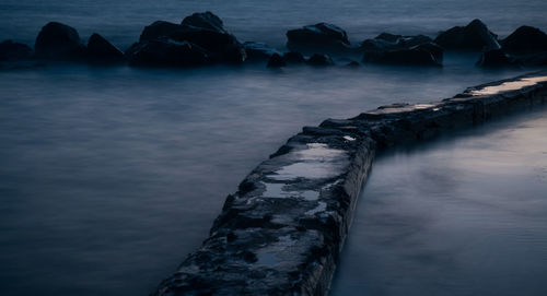 Scenic view of sea against sky during winter