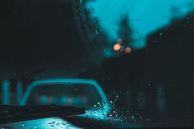 Raindrops on glass window at night