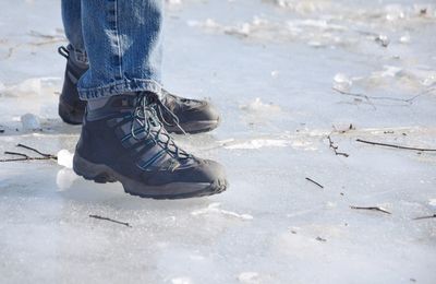 Low section of man standing on ice rink